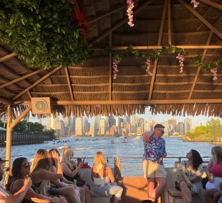 Friends celebrating a birthday party on a private boat rental in NY Harbor