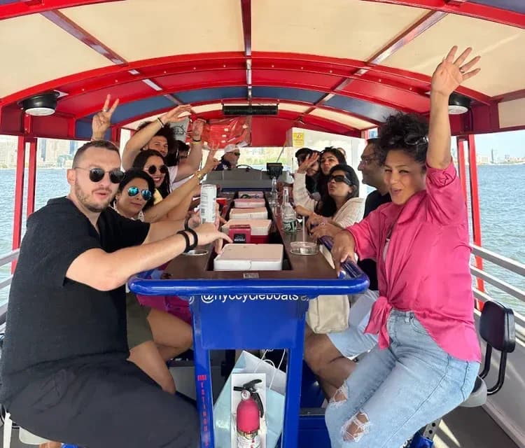 Group of friends celebrating aboard the NYC cycleboat on the Hudson