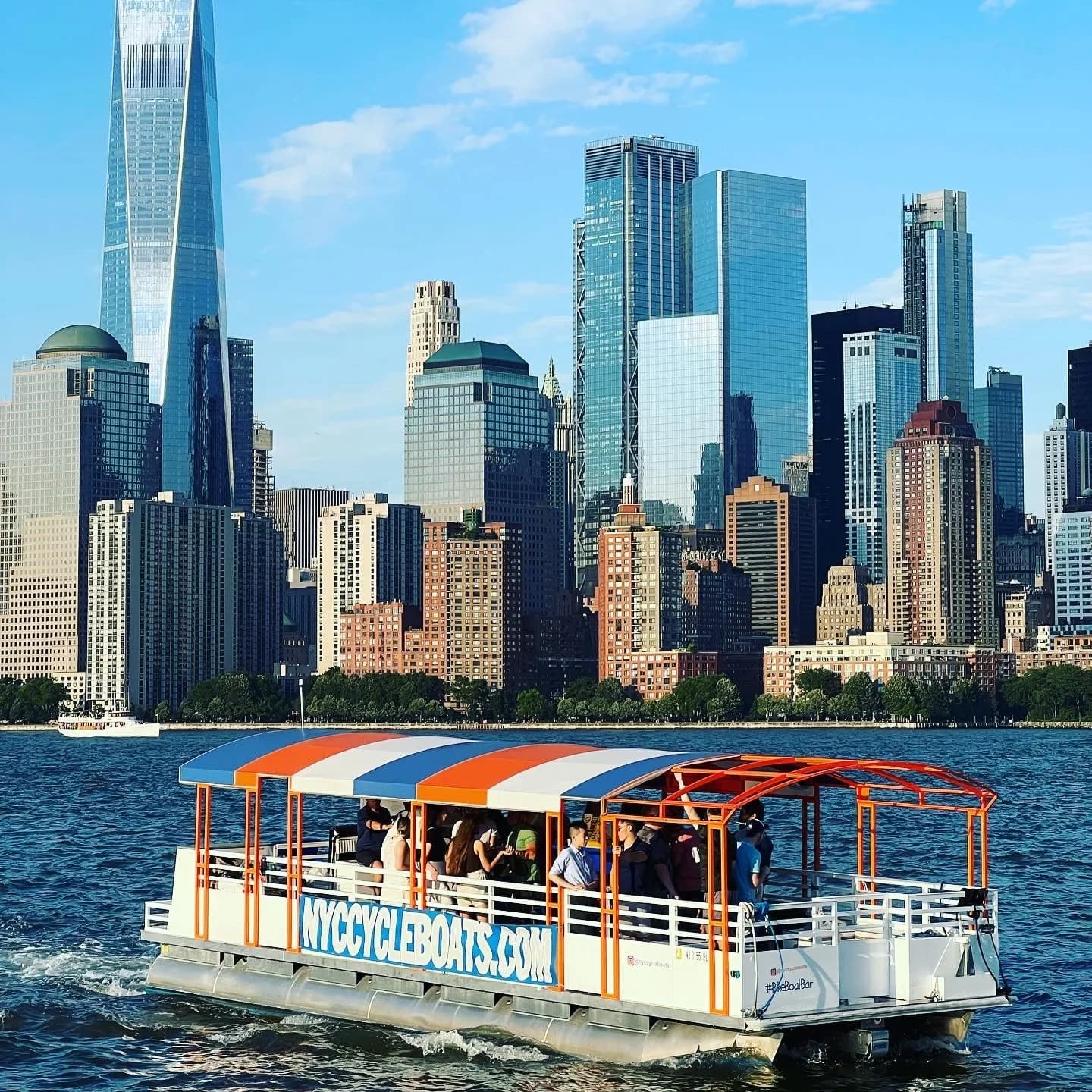 NY Harbor Social cycleboat cruising in front of the Manhattan skyline