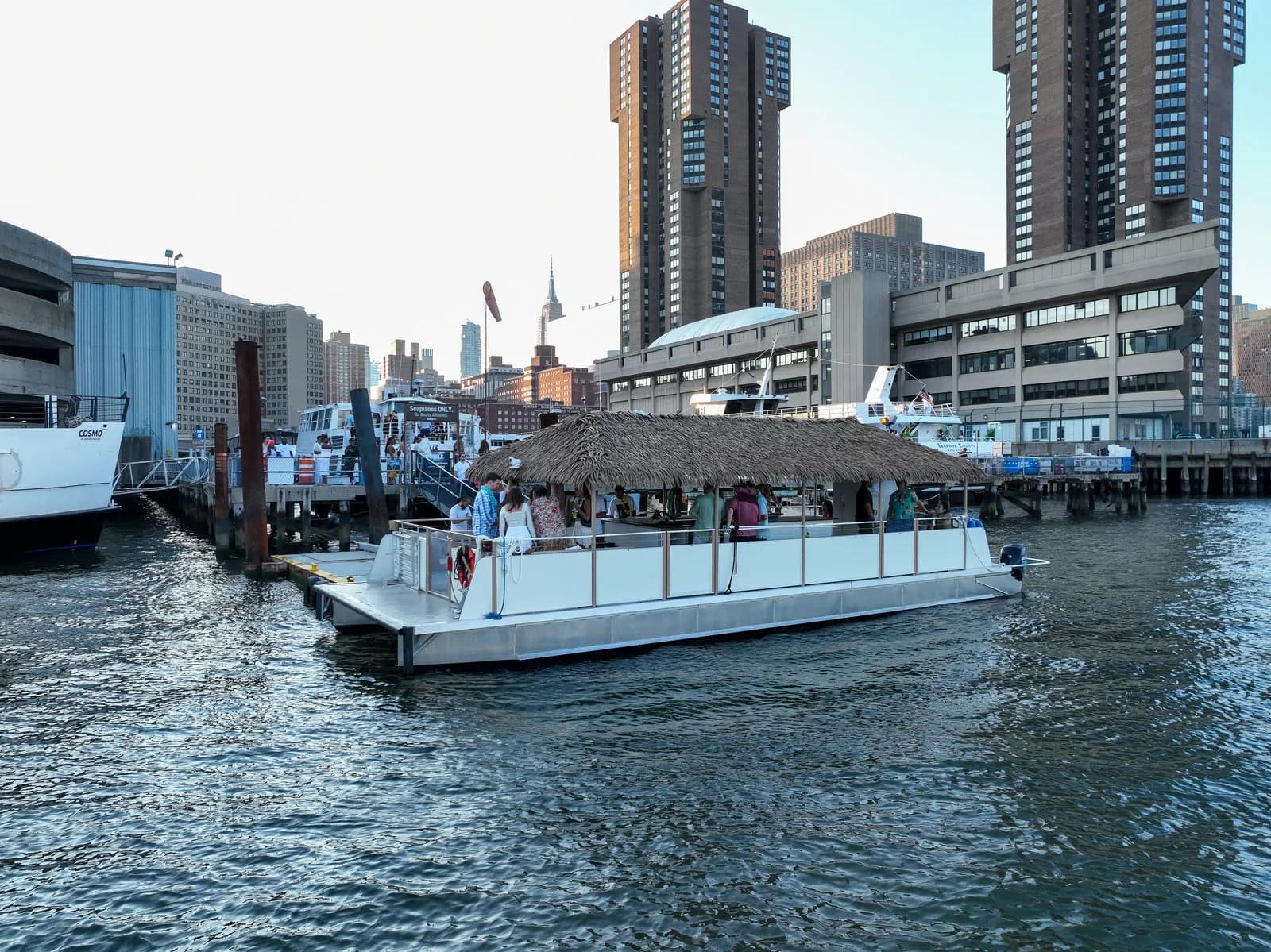 NY Harbor Social tiki boat boarding at a Manhattan marina