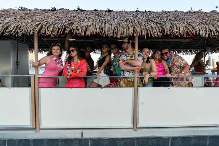 Bachelorette party group under the tiki roof on a NY Harbor boat cruise